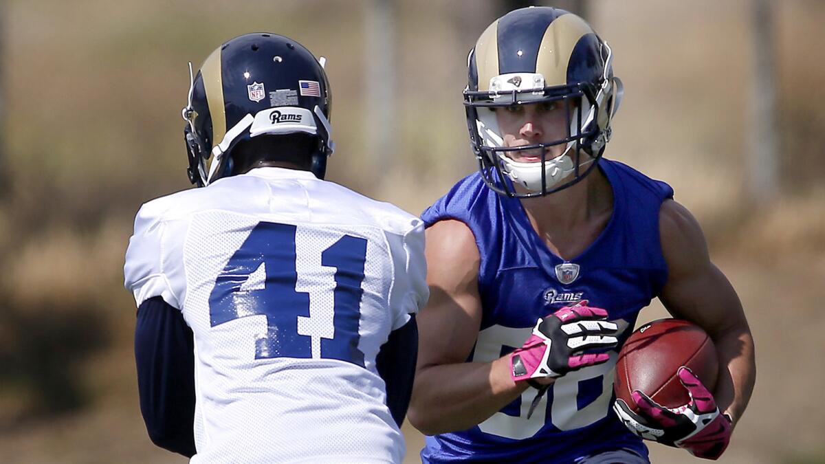 Rams wide reciever Nelson Spruce looks to run past defensive back Winston Rose (41) during mini-camp on Saturday.