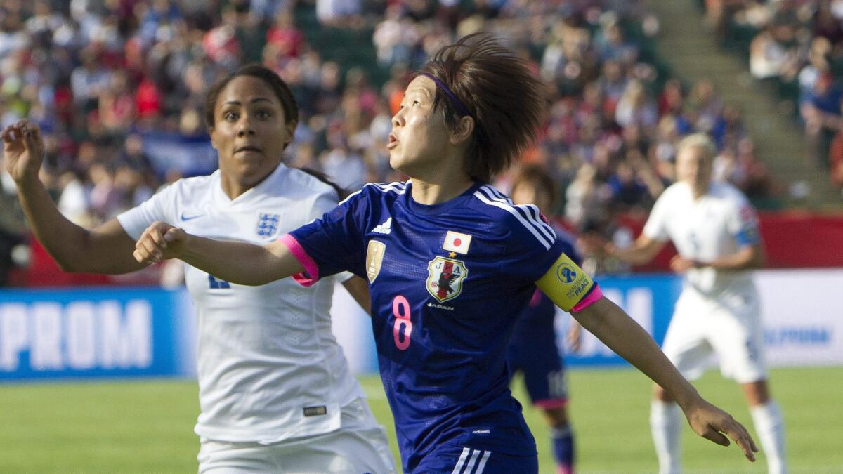 England's Alex Scott, left, and Japan's Aya Miyama battle for the ball during the second half of Japan's semifinal victory in the Women's World Cup on Wednesday.
