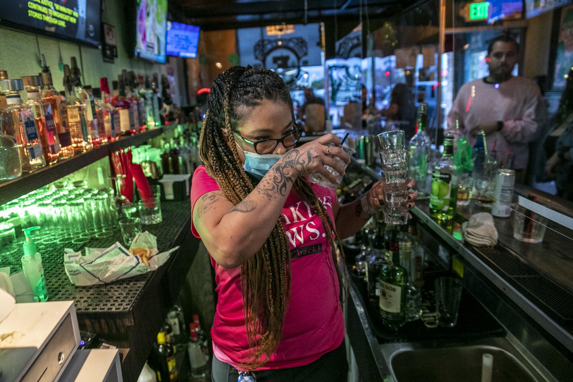 Bartender Christina Flintland serves drinks at Elvie's Public House in Covina.