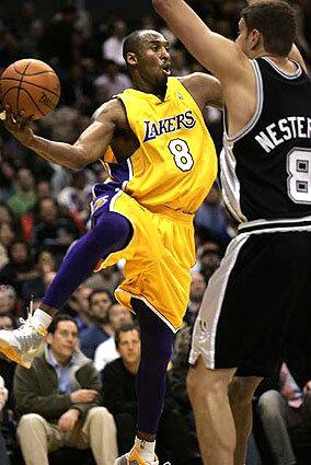 Kobe Bryant is forced to pass of as San Antonio's Rasho Nesterovic provides help on defense.