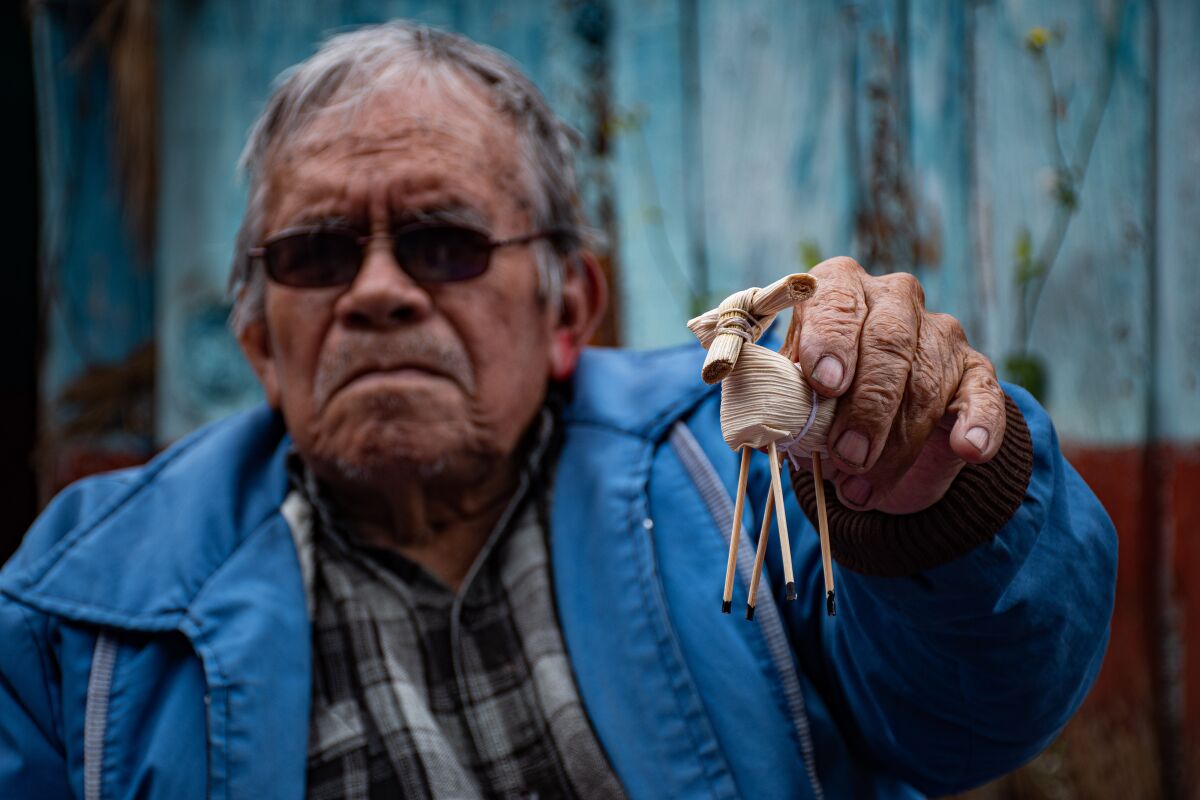 Tomas de Jesus Molina Perez on 15 June 2022 holds up one of the corn husk mules he prepared