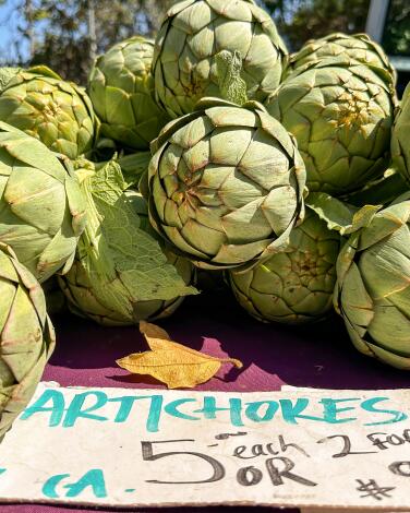 Artichokes on a table at a farmers market