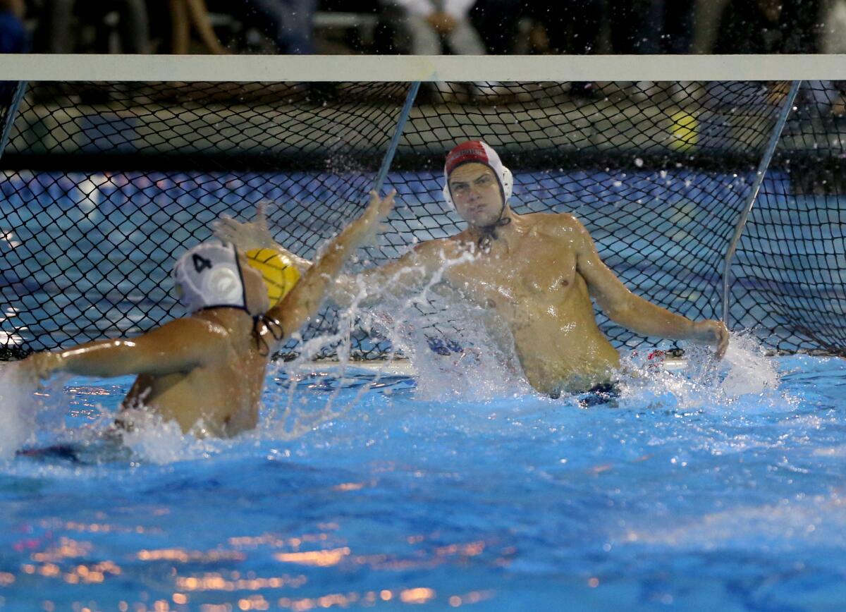 Newport Harbor goalkeeper Blake Jackson makes a save against Harvard-Westlake in the CIF Southern Section Division 1 championship match on Saturday at Woollett Aquatics Center in Irvine.