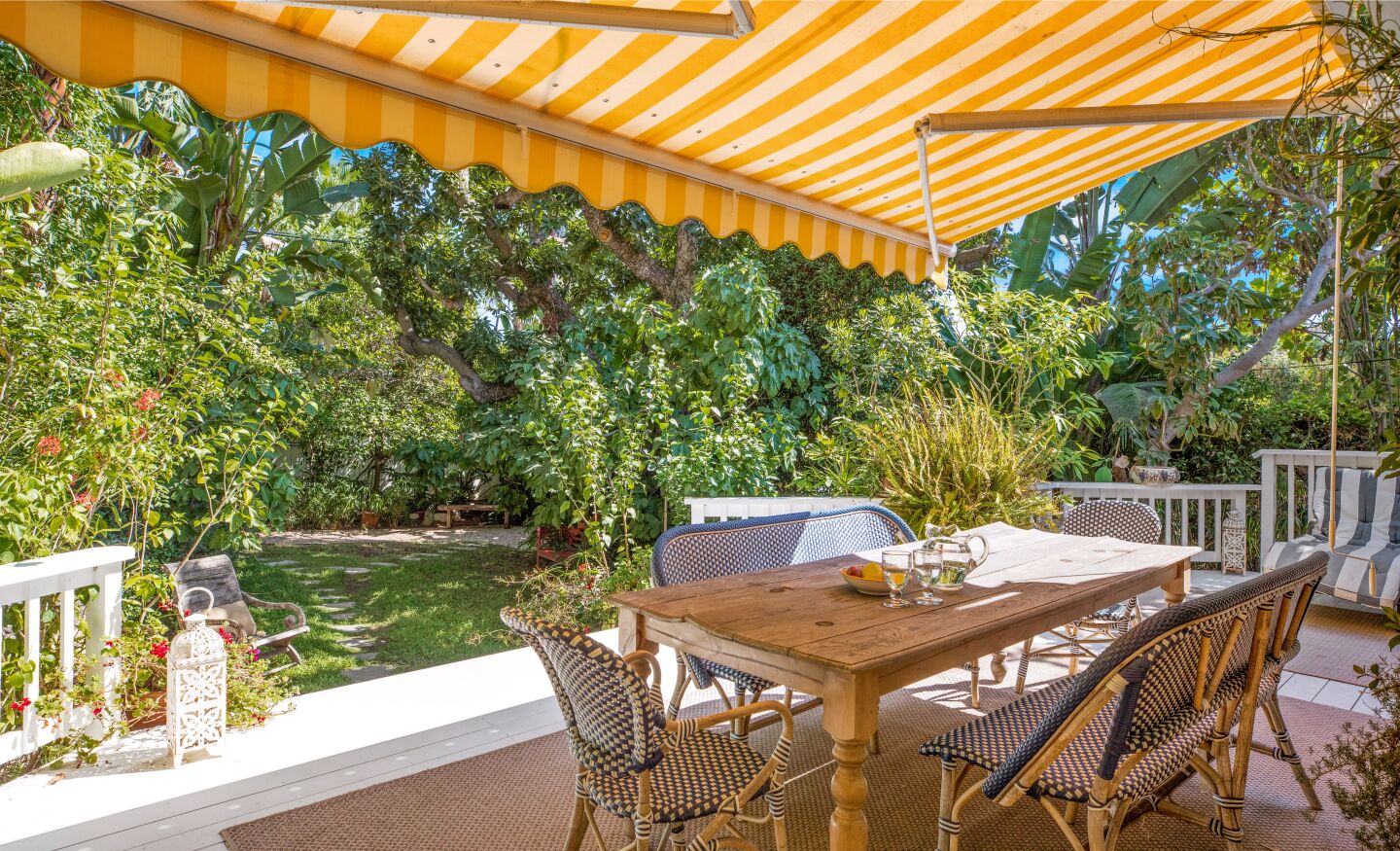 A striped awning shades the back patio.