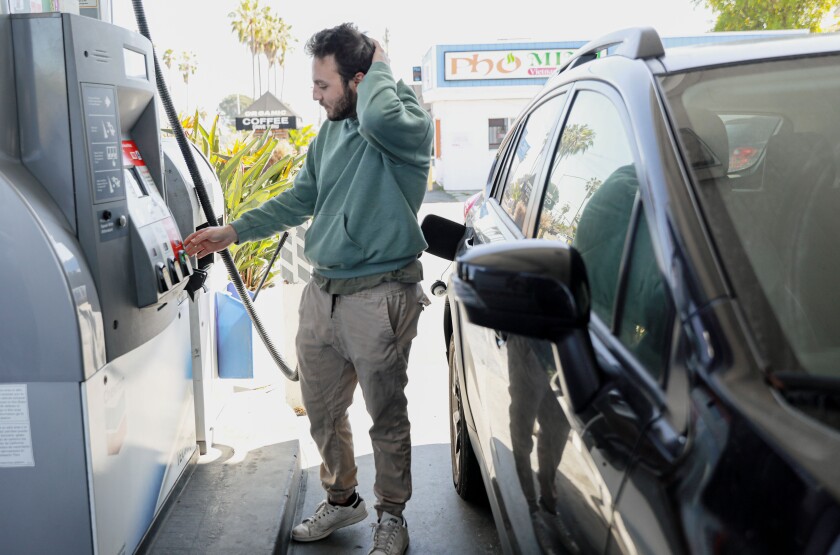 Henry Toubs prepares to fill- up at a Chevron along Garnet Ave and Ingraham St in Pacific Beach in March 