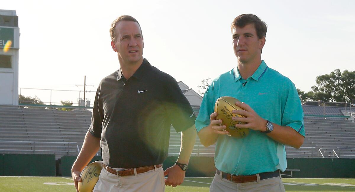 Peyton, left, and Eli Manning visit Newman School in New Orleans, their alma mater, in 2015