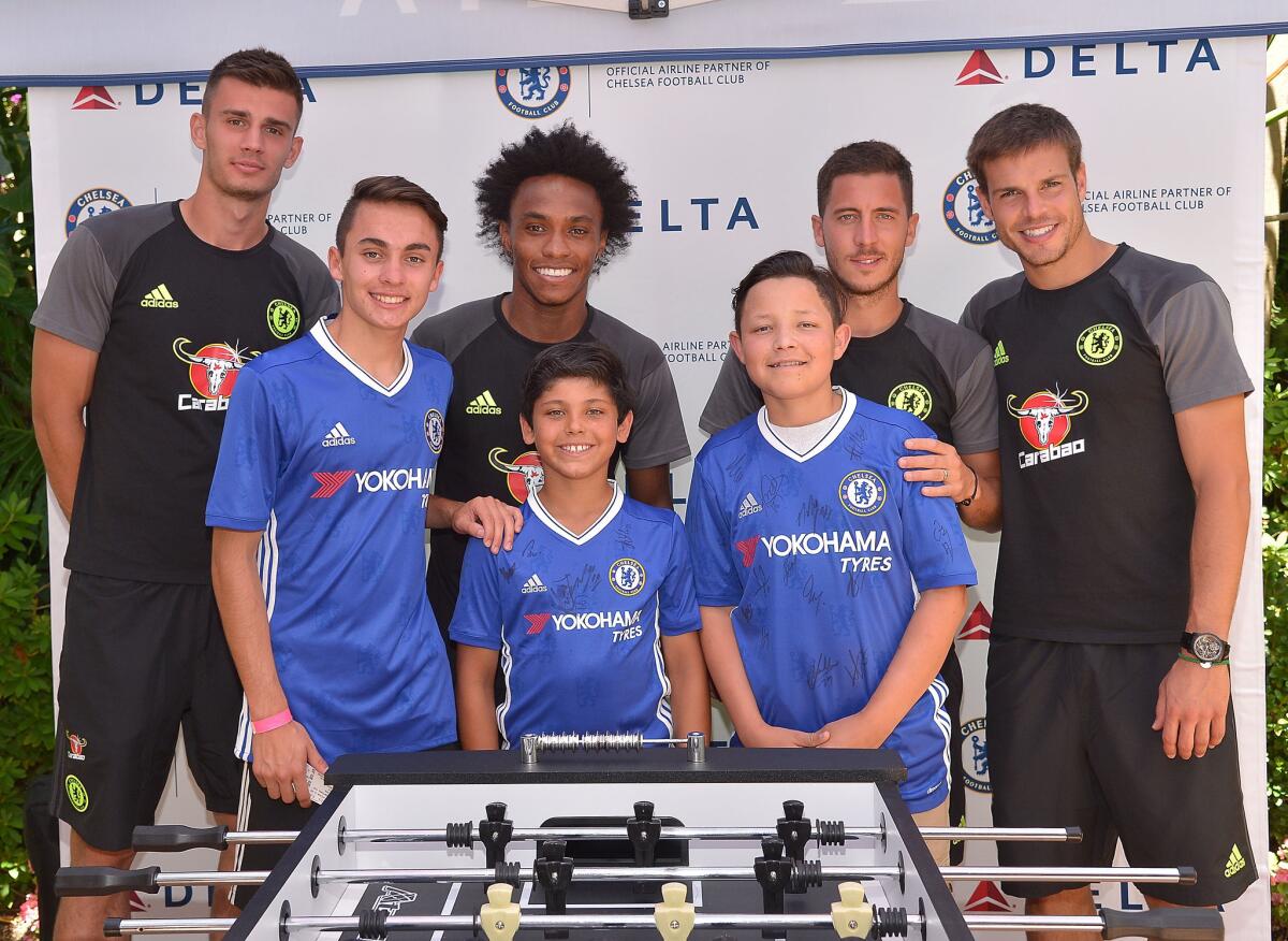 Verdugo Woodlands Elementary student, 10-year old Alex Idolor, stands front center, with players of the Chelsea Football Club Tuesday afternoon. Alex is a patient of Childrens Hospital Los Angeles and a soccer player. He was surprised to learn on Tuesday he will be traveling to London to watch the Chelsea team play during a future game.