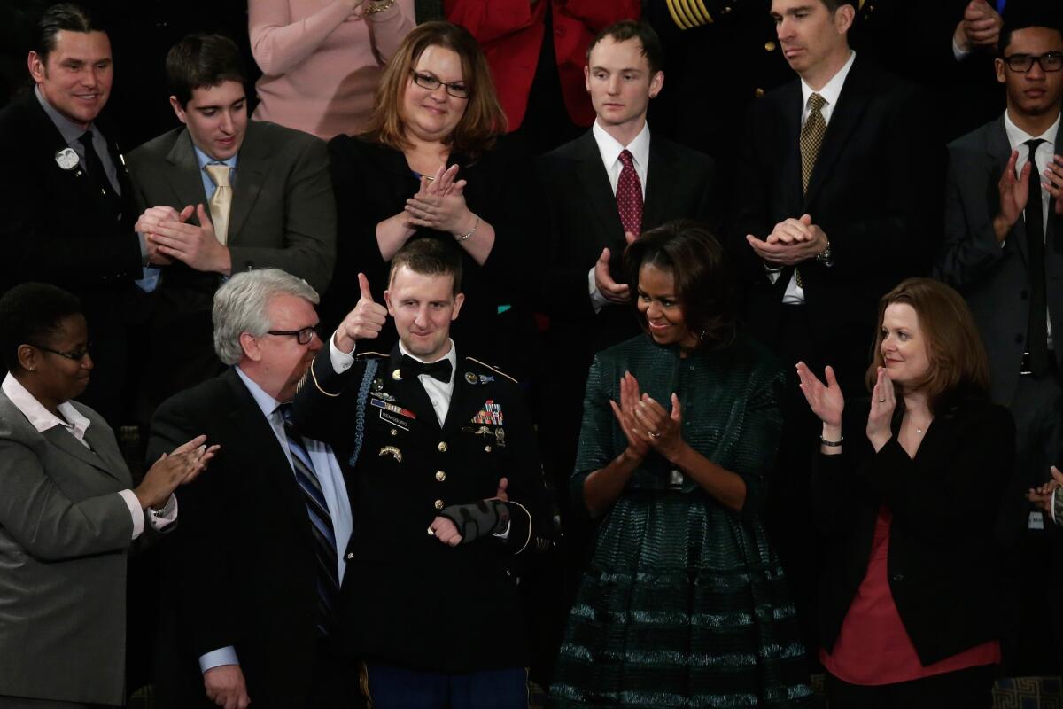 First Lady Michelle Obama applauds as U.S. Army Ranger Cory Remsburg is acknowledged by President Obama during the State of the Union address.
