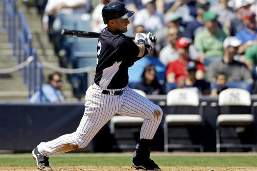 Yankees' Derek Jeter hits a single during a spring training game against the Miami Marlins.