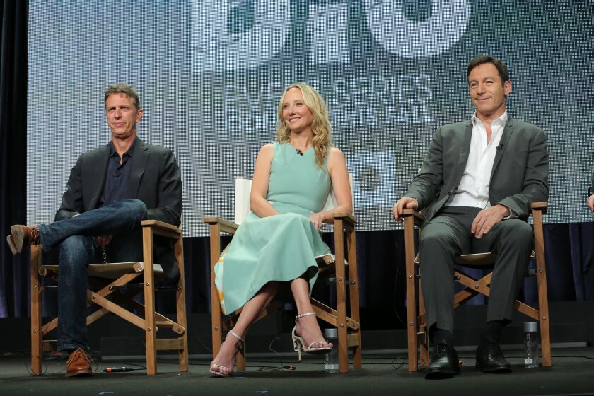 "Dig" co-creator and executive producer Tim Kring, left, is joined by actors Anne Heche and Jason Isaacs to discuss the new USA Network show at the Television Critics Assn. press tour Monday in Beverly Hills.