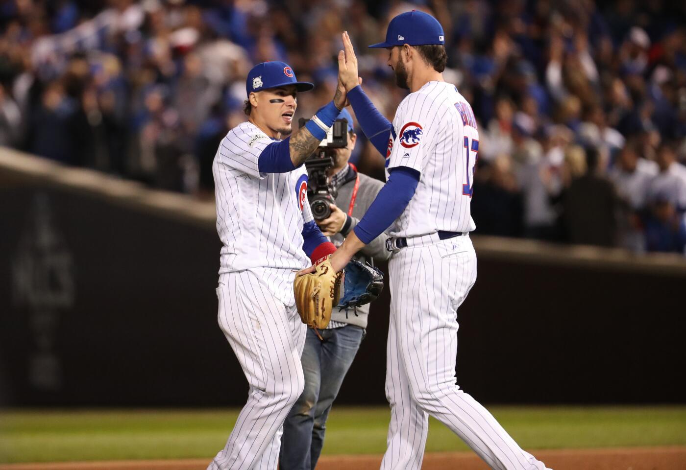 Cubs second baseman Javier Baez (9) and third baseman Kris Bryant (17) celebrate the win over the Dodgers.