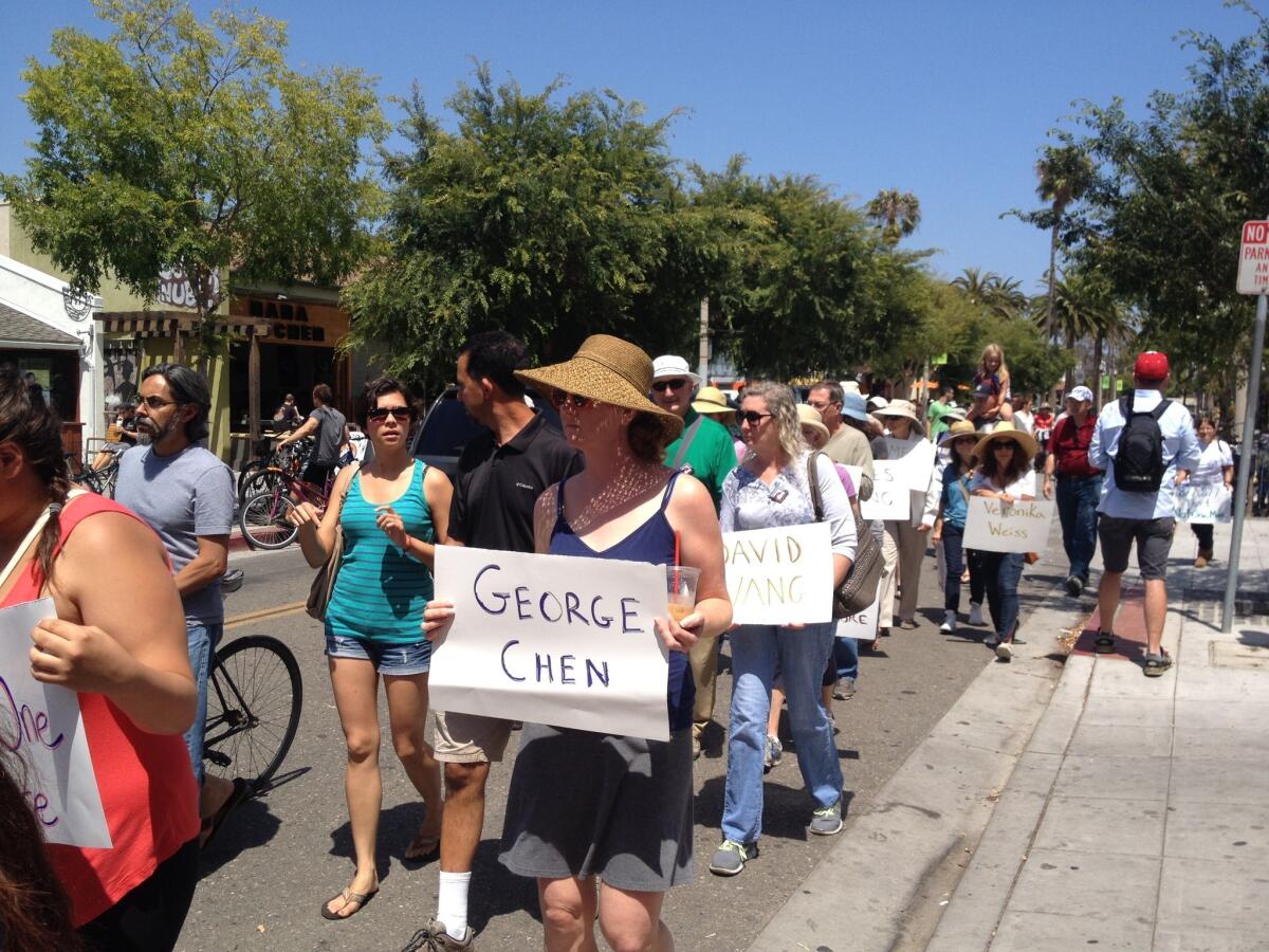 UC Santa Barbara students march through Isla Vista holding signs with the names of the six students who authorities said were killed by Elliot Rodger.