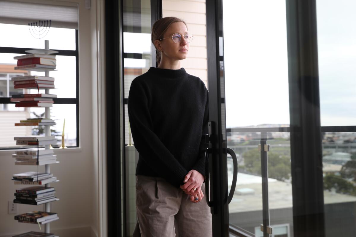 Ariel Friedman looks outside the windows of her home in San Francisco.
