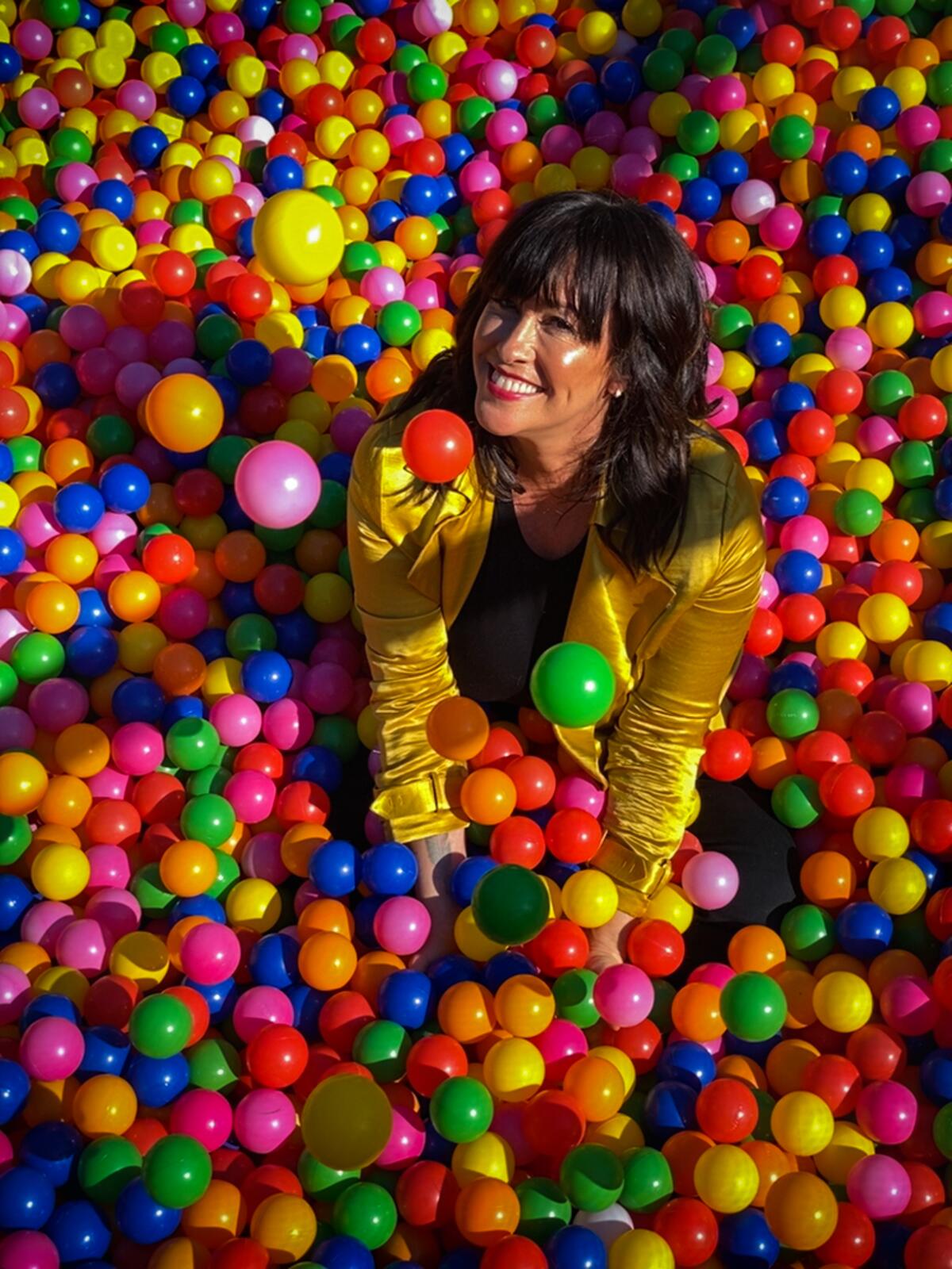 Alanis Morissette sits in a ball pit in her San Francisco backyard