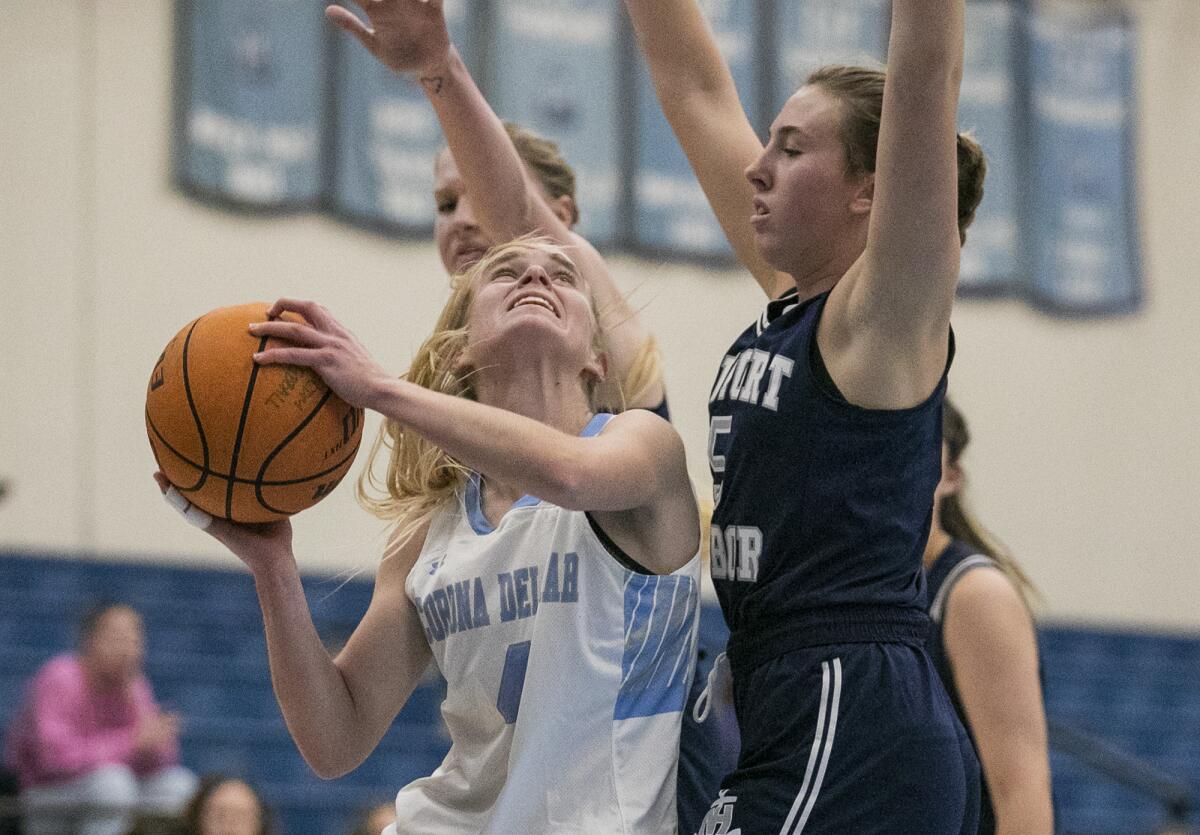 Corona del Mar's Alexa Rokos goes up for a shot against Newport Harbor's Ellie Robinson  on Thursday.