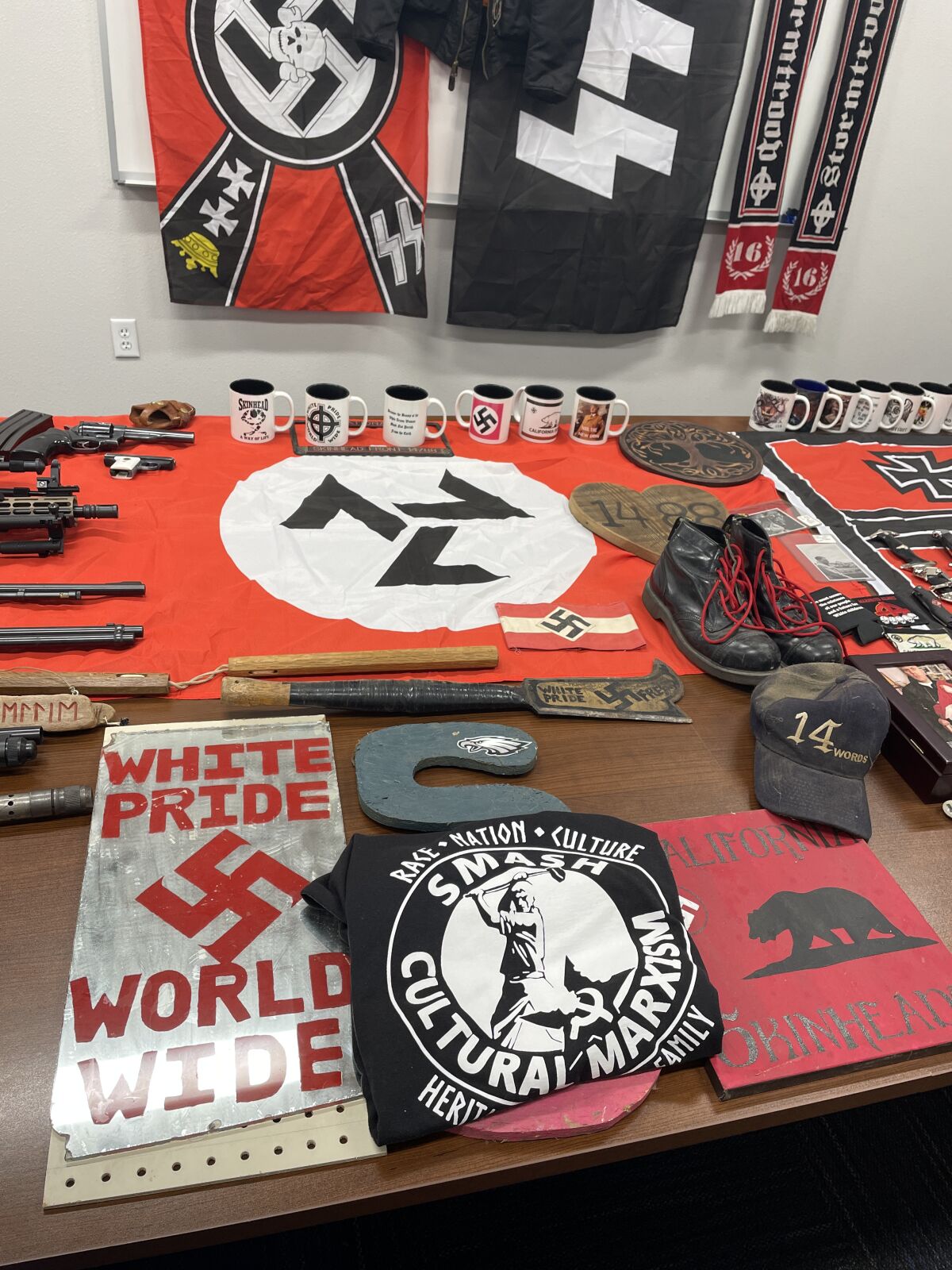 Table covered with variety of items, all featuring Nazi insignia.