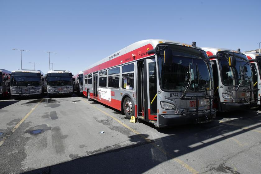 Muni buses are shown at a San Francisco Municipal Transportation Agency yard in San Francisco, Tuesday, April 7, 2020. (AP Photo/Jeff Chiu)