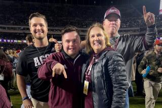Caden Cox, second left, poses for a photo with his brother Zane, left, his mother, Mari, second right, and his father Kevin Cox, at a Texas A&M game in fall 2022. It was taken by a passerby. Zane Cox is is a strength coach at Texas A&M.