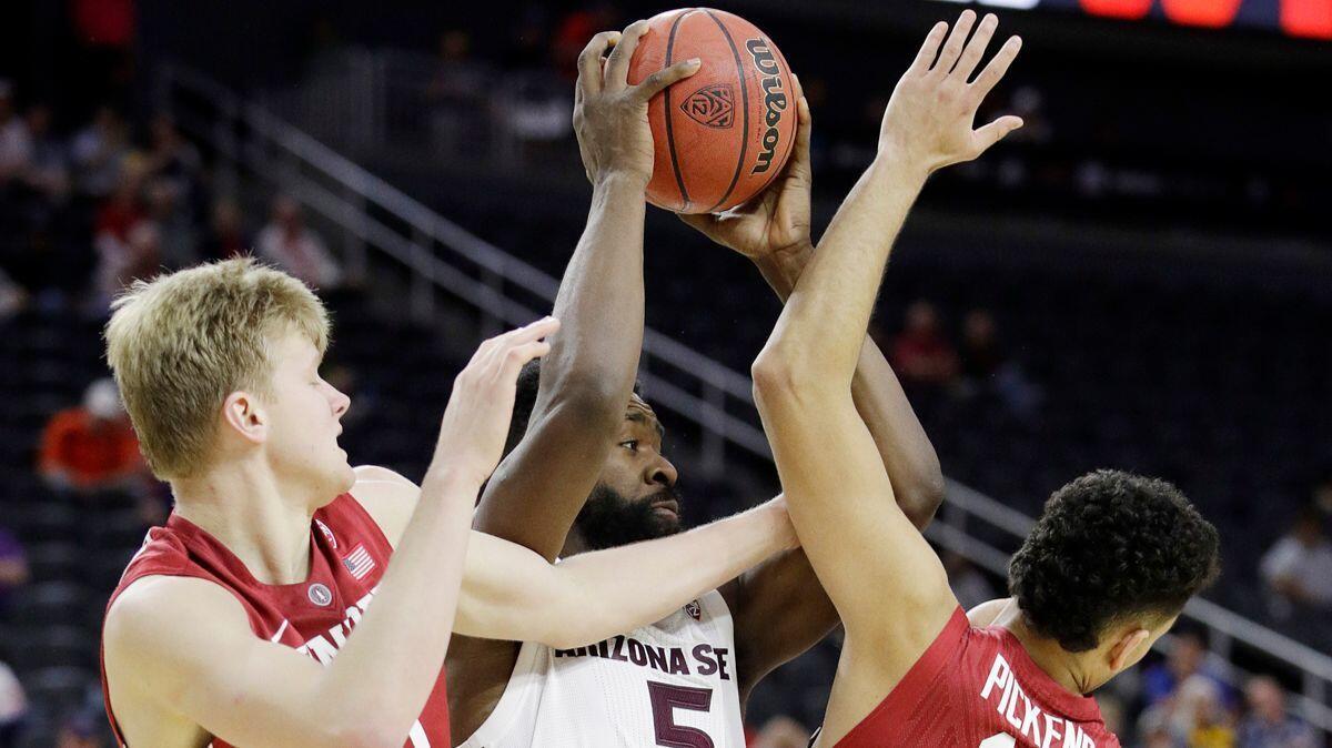 Arizona State's Obinna Oleka (5) battles for the ball with Stanford's Michael Humphrey, left and Dorian Pickens during the second half in the first round of the Pac-12 men's tournament on Wednesday in Las Vegas.