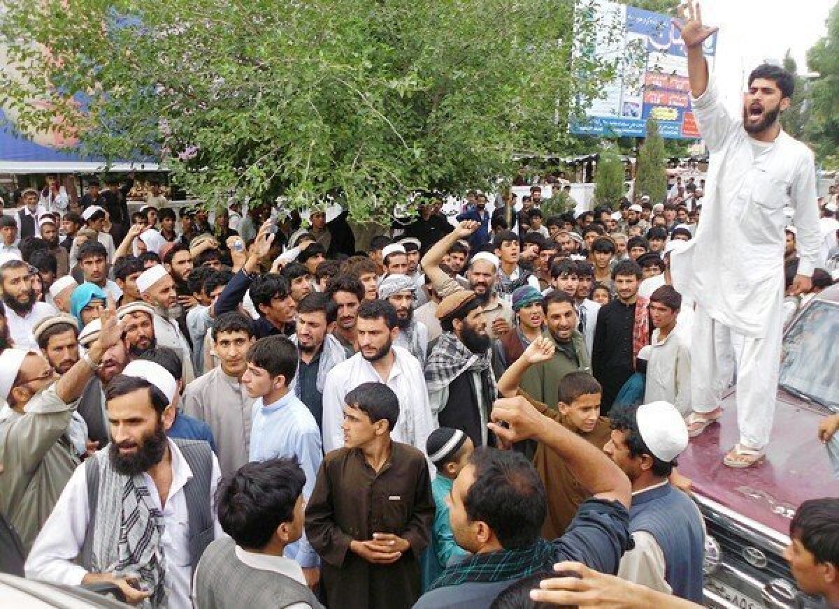 Afghan protesters shout slogans during an anti-NATO protest in the city of Mehtar Lam in Laghman province after eight women were killed in a NATO airstrike.