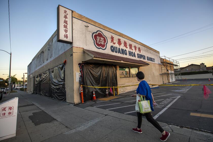 MONTEREY PARK, CA-NOVEMBER 8, 2023, 2023:A pedestrian walks past a closed down market on Garvey Ave. in Monterey Park. The building is available for lease. (Mel Melcon / Los Angeles Times)