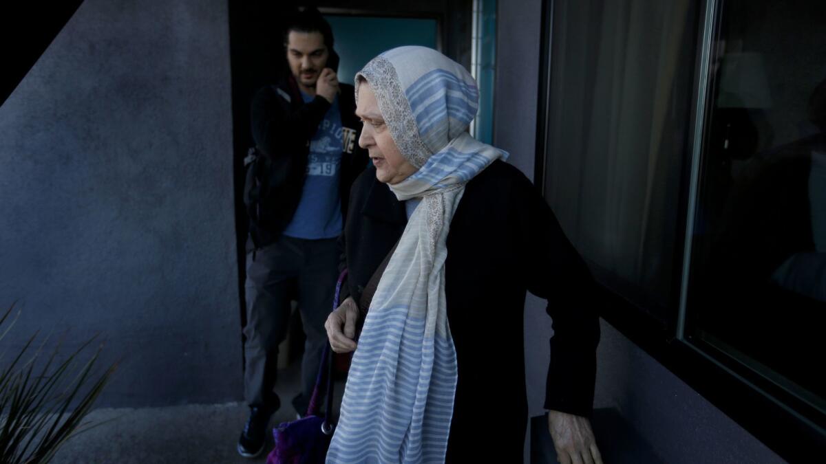 Marzieh Moosavizadeh and her grandson Siavosh Naji-Talakar leave their hotel room in El Segundo after she was detained at LAX.