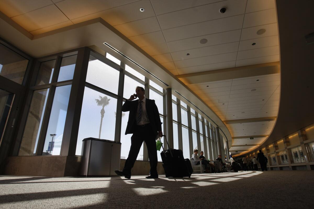 Travelers pass through John Wayne Airport in 2011. A man who hoped to join Islamic State and was stopped at the airport in 2014 was sentenced to 15 years in prison.