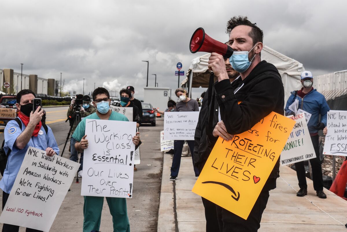 People protest working conditions outside an Amazon fulfillment center on May 1, 2020.