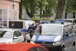 Two judiciary vans, each carrying defendants, drive in a courtyard before the start of the trial against members of the "United Patriots" grouping at the Higher Regional Court in Koblenz, Germany, Wednesday, May 17, 2023. Five people go on trial in Germany on Wednesday accused of planning a far-right coup and plotting to kidnap the country's health minister. (Sebastian Gollnow/dpa via AP)