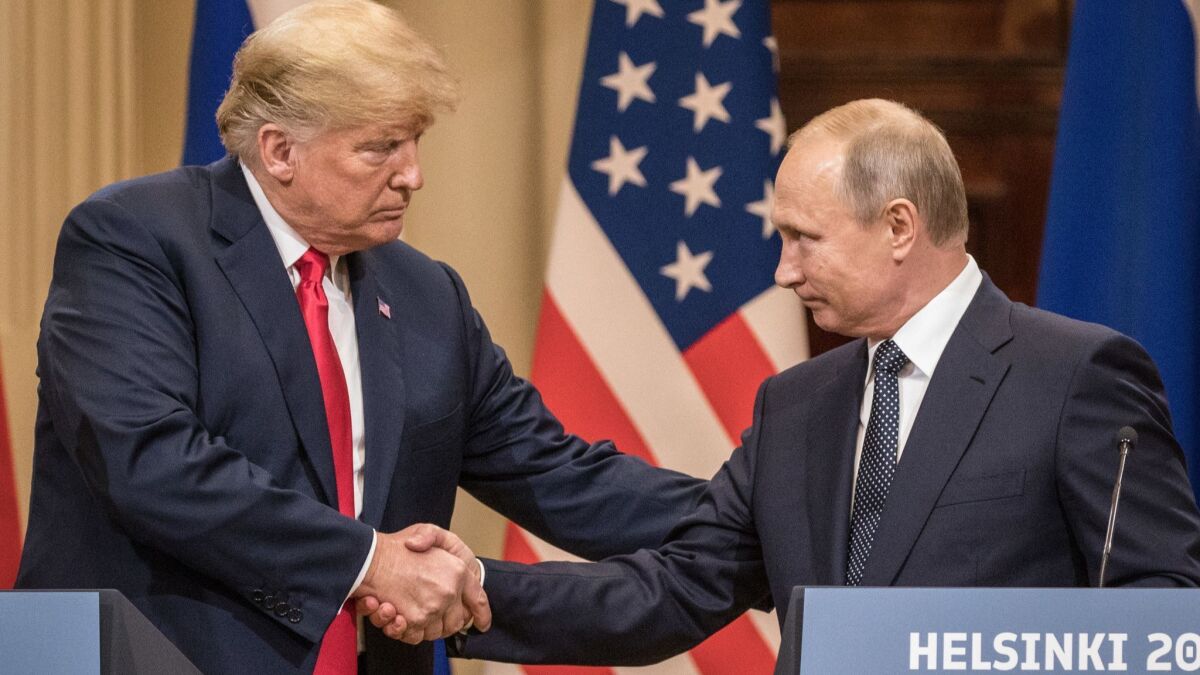 President Trump and Russian President Vladimir Putin shake hands during a joint news conference after their summit in Helsinki, Finland.