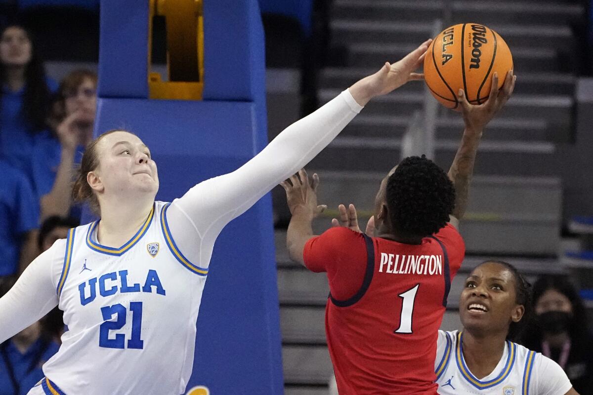 UCLA forward Lina Sontag, left, tries to block a shot by Arizona guard Shaina Pellington during a Wildcats win on Feb. 3.