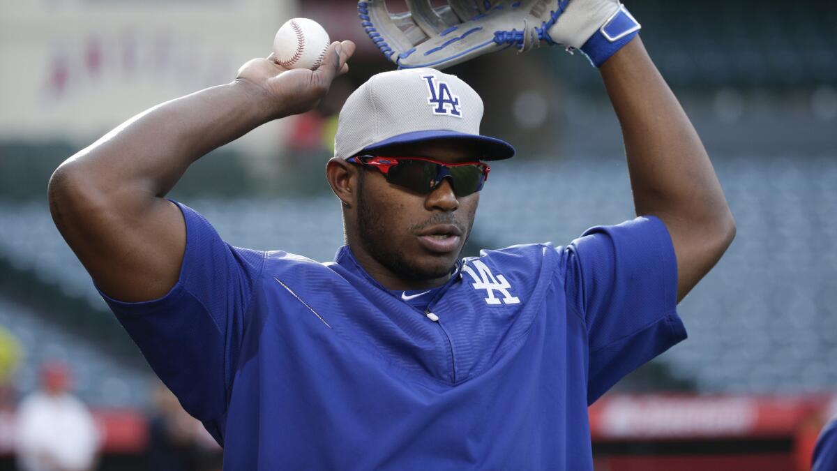 Dodgers center fielder Yasiel Puig stretches while warming up before an exhibition game against the Angels on April 3.