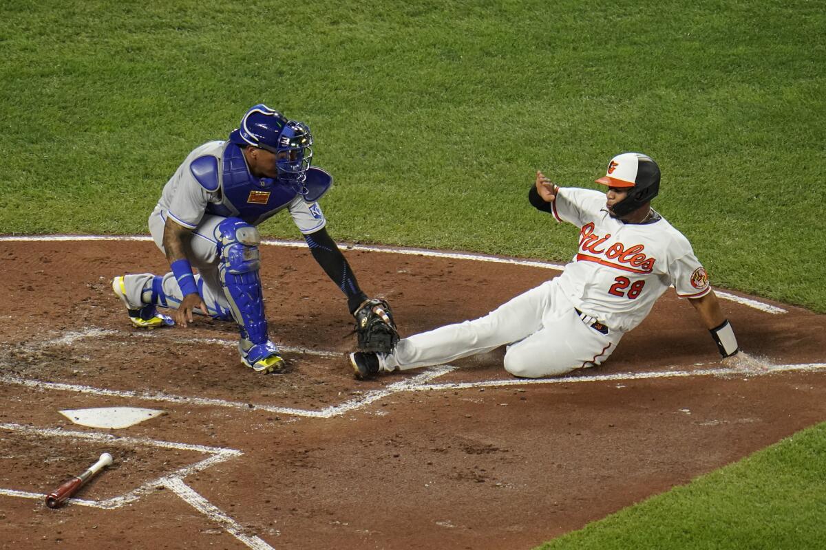Kansas City Royals catcher Salvador Perez, left, tags out Baltimore Orioles' Pedro Severino who was attempting to score on a single by Jahmai Jones during the second inning of a baseball game, Thursday, Sept. 9, 2021, in Baltimore. (AP Photo/Julio Cortez)