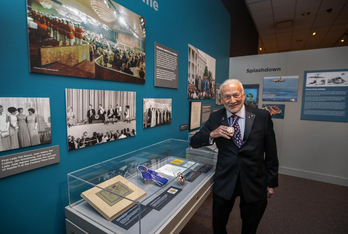 Buzz Aldrin tours a Nixon Library exhibit on space travel.