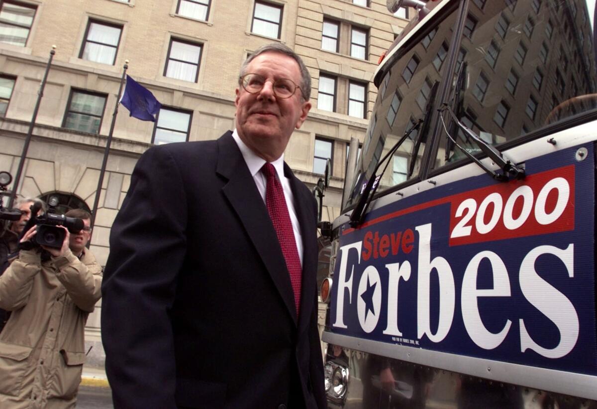 Forbes Media Chairman Steve Forbes walks off his bus during the 2002 Republican presidential primary race.