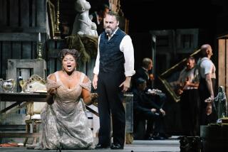 Los Angeles, CA - November 17: Angel Blue, left, and Ryan McKinny, right, perform during a dress rehearsal of L.A. Opera's Tosca at Dorothy Chandler Pavilion on Thursday, Nov. 17, 2022 in Los Angeles, CA. (Dania Maxwell / Los Angeles Times)