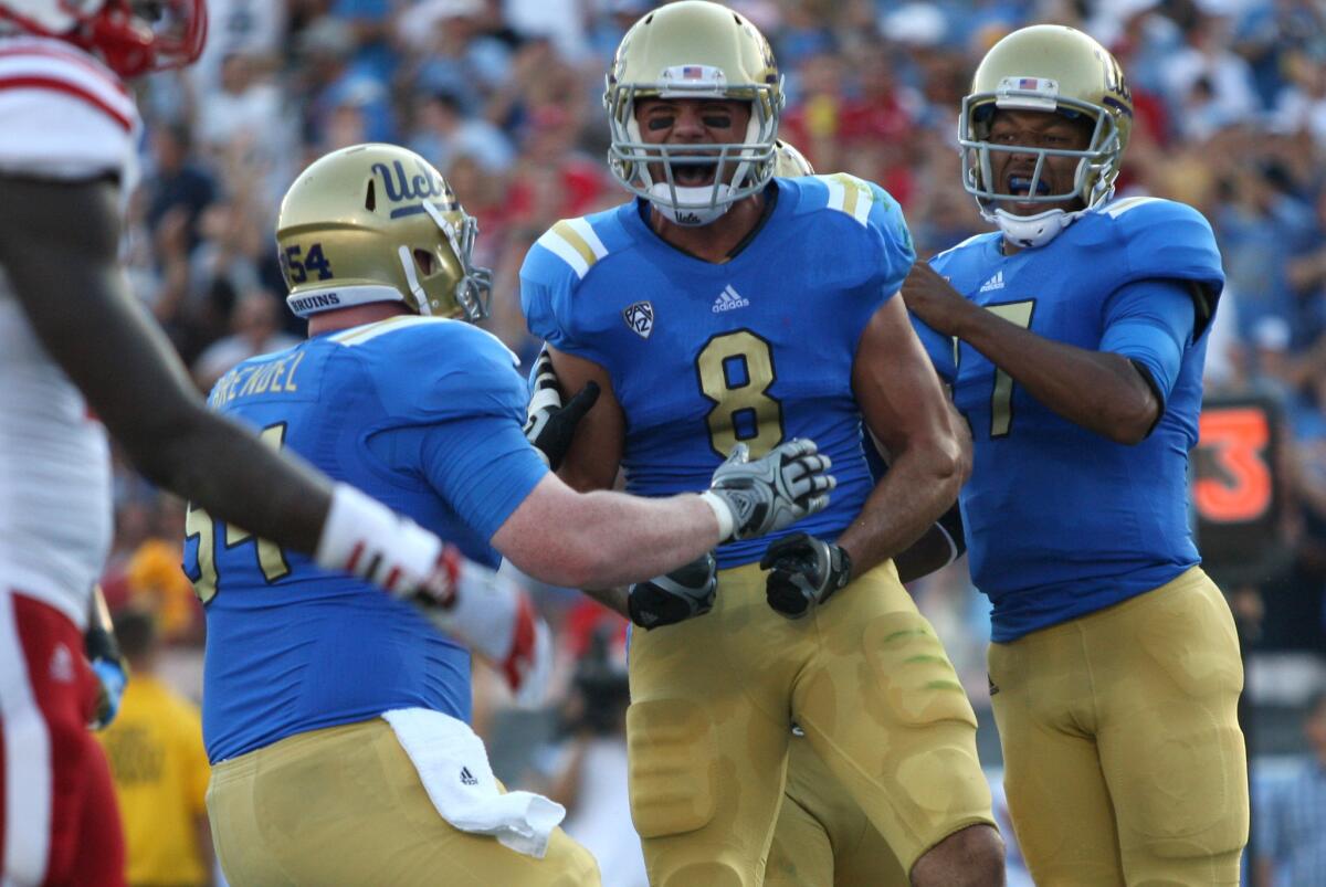 UCLA center Jake Brendel, left, and quarterback Brett Hundley, right, celebrate Joseph Fauria's second-quarter touchdown against Nebraska in 2012.