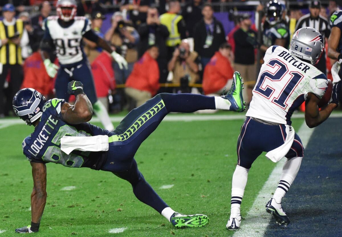 Malcolm Butler of the New England Patriots, right, intercepts a pass intended for Ricardo Lockette of the Seattle Seahawks late in the fourth quarter of Super Bowl XLIX.