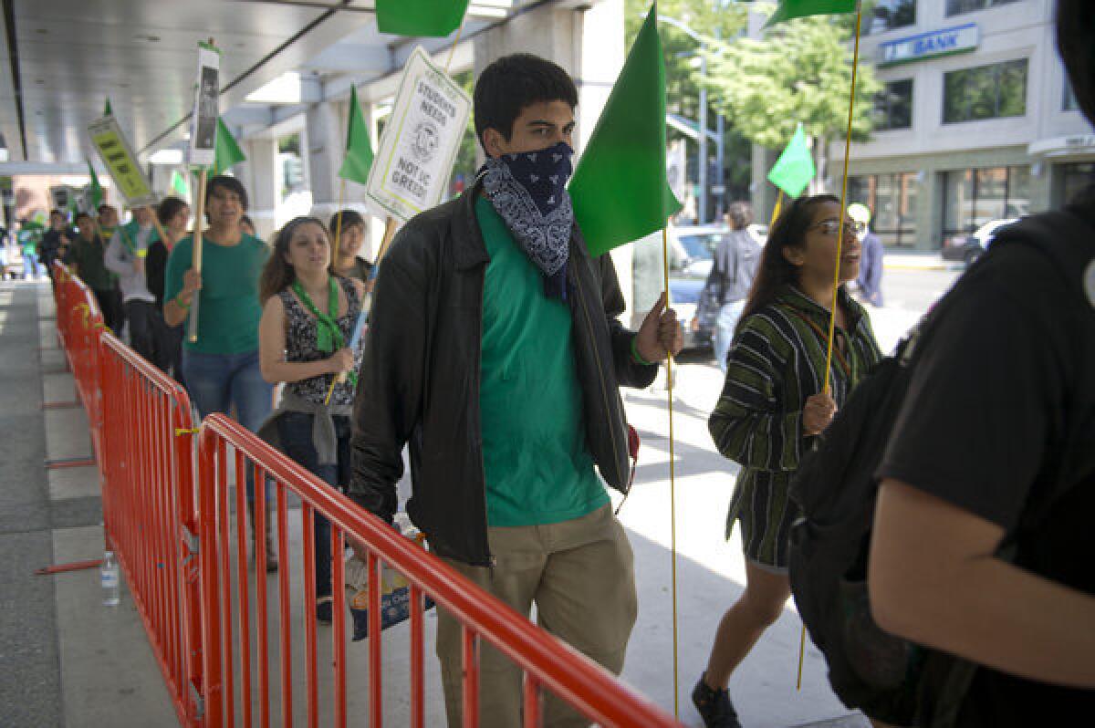 Protesters rally in front of the Sacramento Convention Center on Wednesday in support of University of California's AFSCME 3299 workers as UC Regents meet inside.