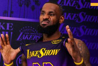 LeBron James makes a funny face as he tries on the Lakers' City Edition uniform for the 2024-2025 season.