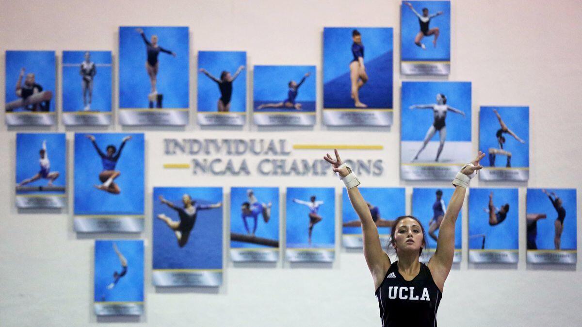 Angi Cipra puts her arms up as she visualizes her floor routine during practice at UCLA.