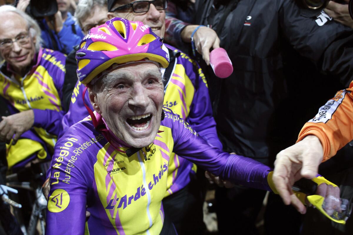 FILE- In this Jan.4, 2017 file photo, French cyclist Robert Marchand, 105, reacts after setting a record for distance cycled in one hour, at the velodrome of Saint-Quentin en Yvelines, outside Paris. Robert Marchand, the world's oldest bike racing competitor who lived through two World Wars and set a world record only four years ago, has died. He was 109. (AP Photo/Thibault Camus, File)