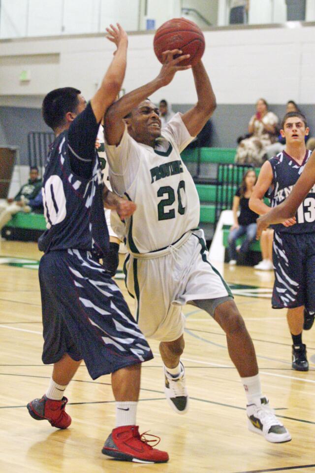 Providence's Marcus LoVett Jr., right drives to the basket during a game against Knights at Providence High School in Burbank on Tuesday, November 27, 2012.