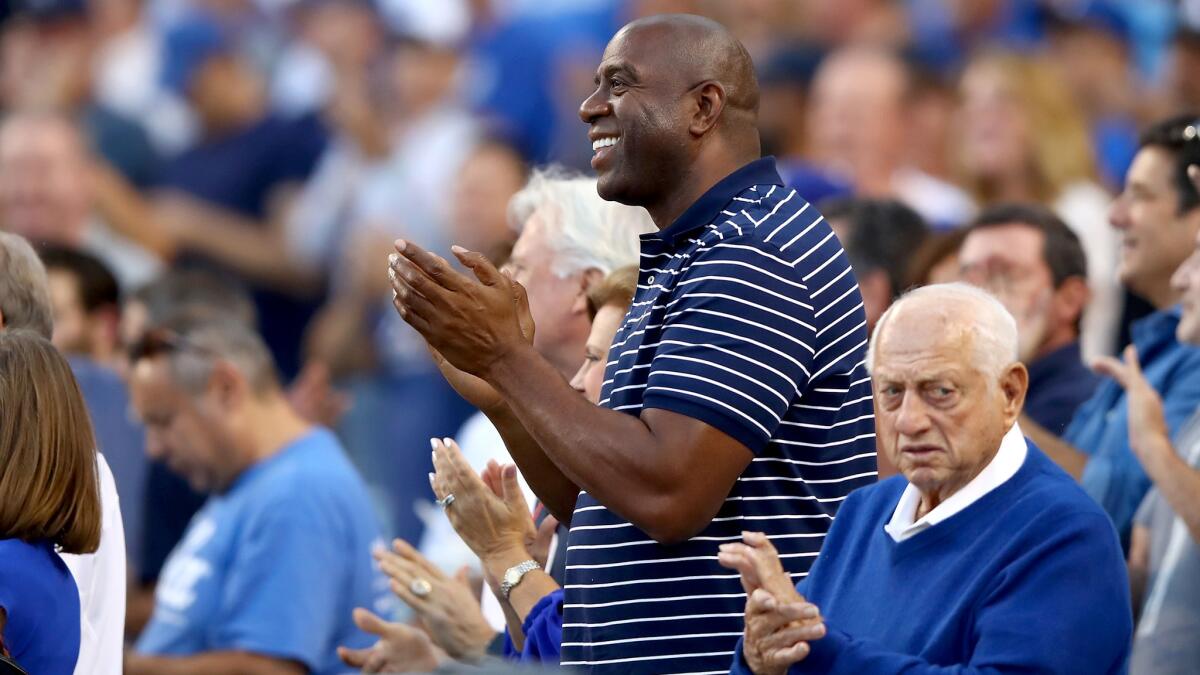 Magic Johnson and former Dodgers manager Tommy Lasorda attend Game 1 of the NLCS at Dodger Stadium last week.
