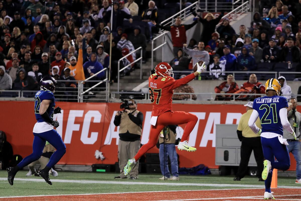 Chiefs tight end Travis Kelce (87) completes a pass for a touchdown against the NFC in the second quarter of the NFL Pro Bowl on Jan. 29.