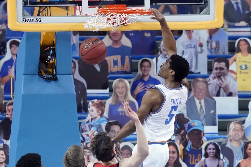 UCLA guard Chris Smith (5) dunks against Utah during the first half of an NCAA.
