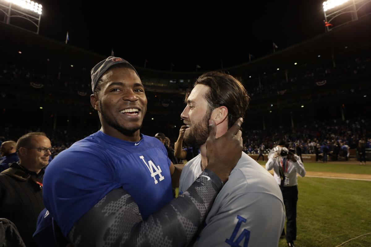 Los Angeles Dodgers' Yasiel Puig and Charlie Culberson celebrate after Game 5 of baseball's National League Championship Series against the Chicago Cubs, Thursday, Oct. 19, 2017, in Chicago. The Dodgers won 11-1 to win the series and advance to the World Series.