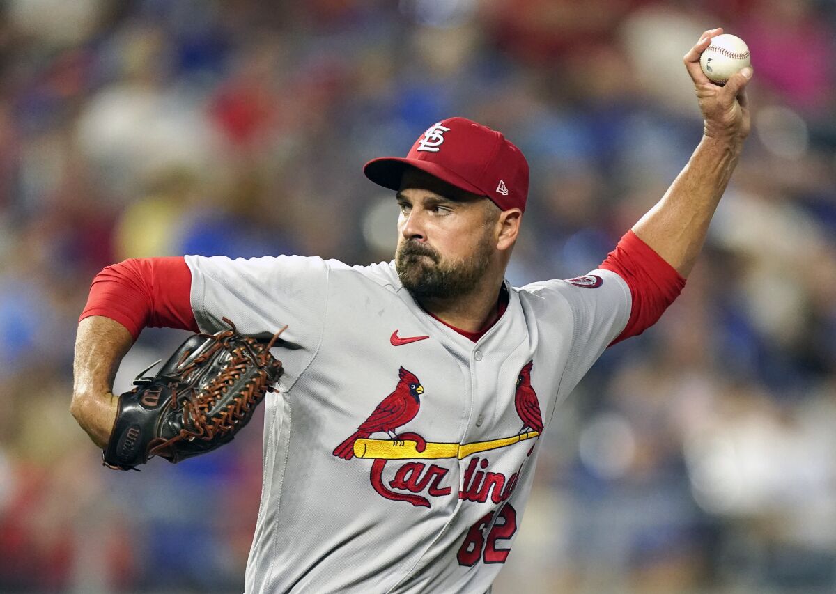 FILE - St. Louis Cardinals relief pitcher T.J. McFarland throws during the seventh inning of a baseball game against the Kansas City Royals, Friday, Aug. 13, 2021, in Kansas City, Mo. Left-handed reliever McFarland became the first of this year's major league free agents to reach an agreement, getting a one-year contract to stay with the Cardinals. (AP Photo/Charlie Riedel, File)