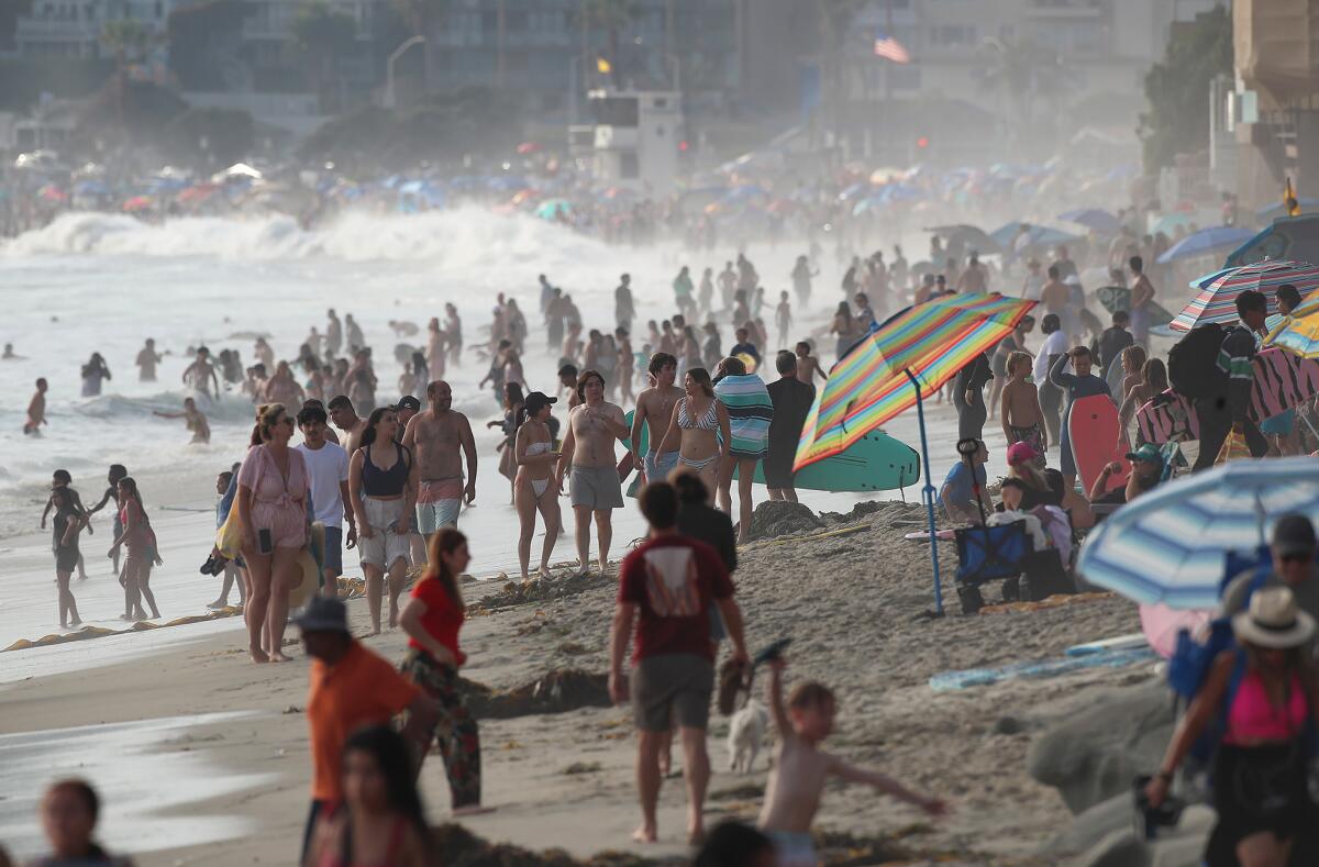 The Laguna Beach coastline looking north to Main Beach Park shows the wall-to-wall crowds on the Fourth of July weekend. 