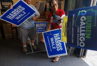 Campaign workers with candidate signs